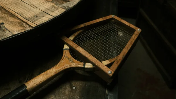 Vintage wooden paddle on a wooden surface